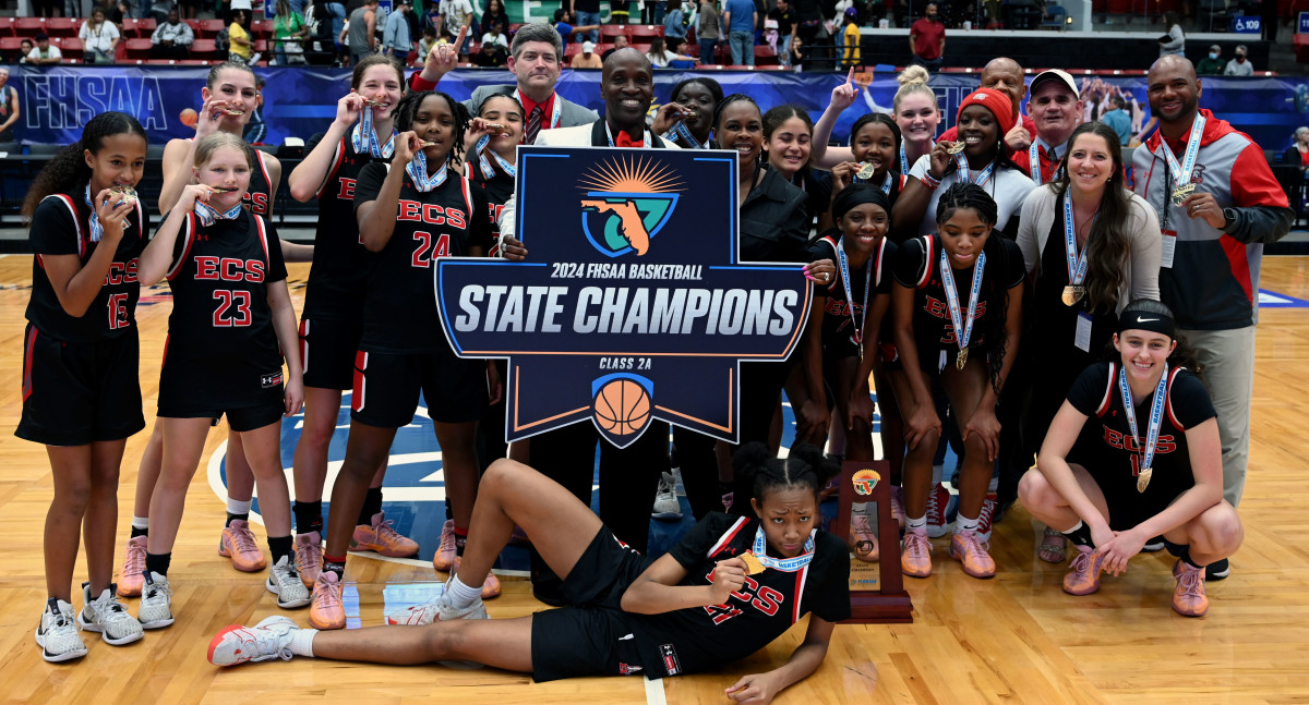 Evangelical Christian Academy get together with their championship trophy after winning the Class 2A girls basketball state championship on Thursday at the RP Funding Center in Lakeland. Evangelical defeated Central Florida Christian Academy.